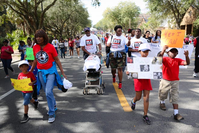 Community leaders and residents march on E. University Avenue in honor of Dr. Martin Luther King Jr., during the King Celebration 2017 National Holiday Kick-Off event.

Rob C. Witzel / The Gainesville Sun