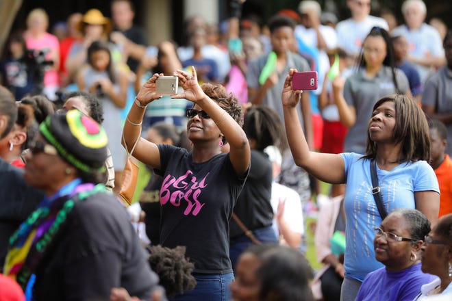 Attendees take pictures during the King Celebration 2017 National Holiday Kick-Off event in honor of the late Dr. Martin Luther King Jr. at Bo Diddley Downtown Community Plaza Monday, January 16, 2017 in Gainesville Fla.

Rob C. Witzel / The Gainesville Sun