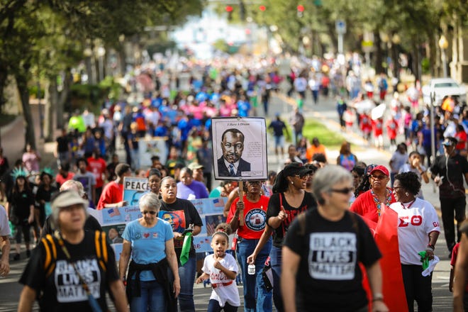 Community leaders and residents march on E. University Avenue in honor of Dr. Martin Luther King, Jr., during the King Celebration 2017 National Holiday Kick-Off event Monday, January 16, 2017.

Rob C. Witzel / The Gainesville Sun