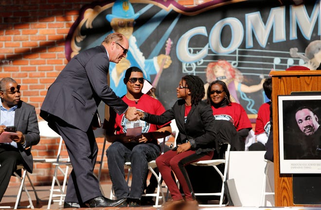 U.S. Representative Ted Yoho congratulates Santa Fe High School senior and 2015 Keeper of the Dream award winner Joni Perkins during the King Celebration 2015 National Holiday Kick-Off event at Bo Diddley Downtown Community Plaza Monday, January 19, 2015. (Doug Finger/The Gainesville Sun)