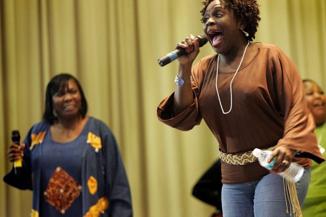01/18/10 -- Gainesville, FL. -- Psalmist Charlotte Ellis Colbert (right) belts out a verse of "Encourage Yourself" during a performance with her mother Evangelist Gladys Ellis (left) at the Martin Luther King Commissions 2010 King National Holiday Gospel Celebration Monday afternoon at the M.L.K. Rec. Center. (Photo by: Brad McClenny / Special to the Sun)