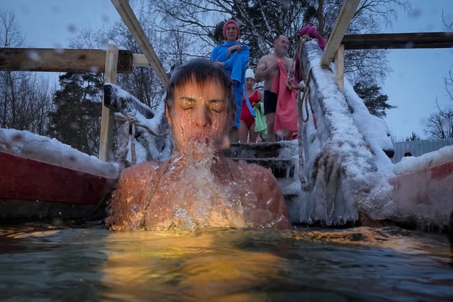 January 19, 2024: A Russian Orthodox believer dips in the icy water during a traditional Epiphany celebration, in St. Petersburg, Russia. Thousands of Russian Orthodox Church followers plunged into icy rivers and ponds across the country to mark Epiphany, cleansing themselves with water deemed holy for the day. The temperature in St.Petersburg is -4 Celsius (24 Fahrenheit).
