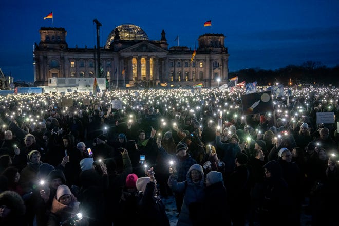 January 21, 2024 : People hold up their cell phones as they protest against the AfD party and right-wing extremism in front of the Reichstag building in Berlin, Germany, Sunday, Jan. 21, 2024.