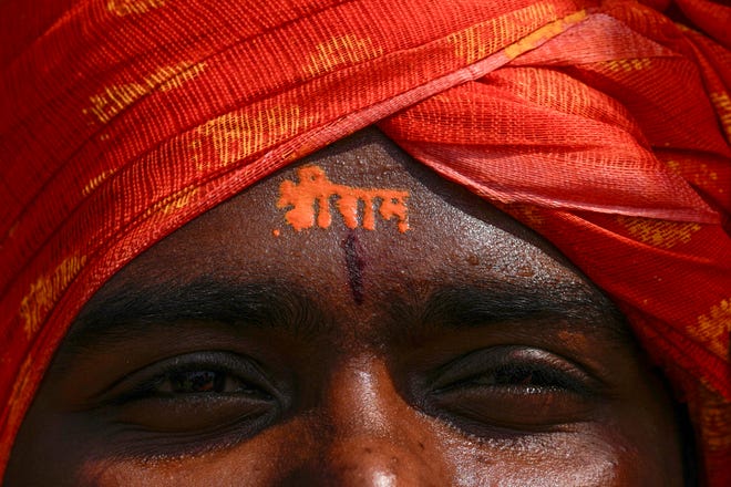 January 22, 2024: A Hindu devotee has the words 'Sri Ram' written on his forehead as he watches in Hyderabad, India, a live telecast of the inauguration of a temple dedicated to the Hindu Lord Ram in northern Ayodhya. Indian Prime Minister Narendra Modi on Monday opened a controversial Hindu temple built on the ruins of a historic mosque in the holy city of Ayodhya in a grand event that is expected to galvanize Hindu voters in upcoming elections.