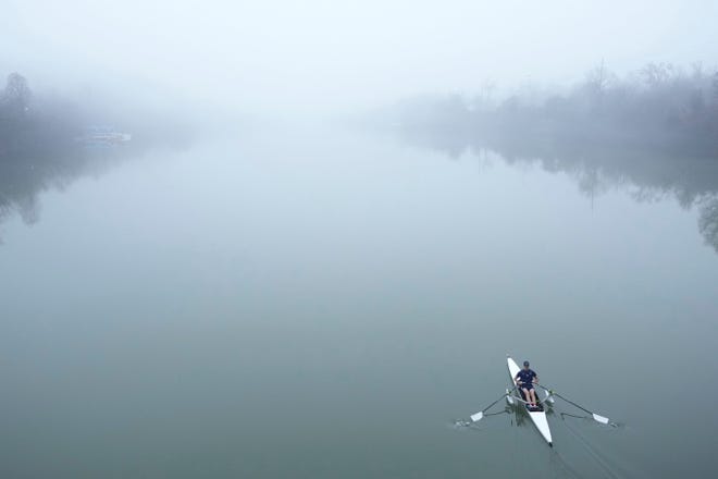 January 23, 2024: A sculler glides on Lady Bird Lake in a dense fog in Austin, Tx.