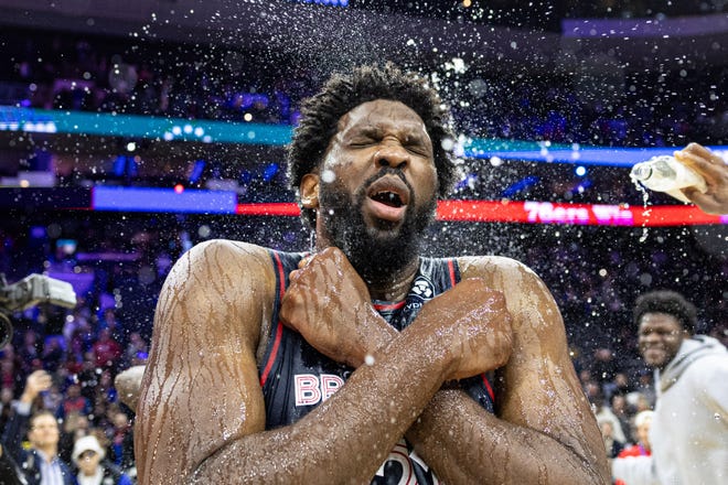 76ers center Joel Embiid is doused with water by teammates after scoring 70 points in a victory against the Spurs.