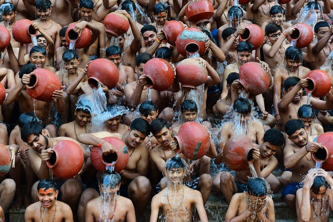 January 24, 2024 : Students from the Swaminarayan Gurukul school take part in a 'Magh Snan' or holy bath in Ahmedabad, India.