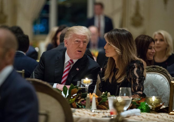 President Donald Trump, center, and first lady Melania Trump, sit with their family for Thanksgiving Day dinner at Mar-a-Lago in Palm Beach. [GREG LOVETT/PALMBEACHPOST.COM]