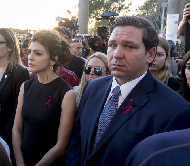 Governor Ron DeSantis and his wife Casey attend an interfaith ceremony honoring the memory of those who lost their lives at MSD High School last year, Thursday evening inside Pine Trails Park, in Parkland, Florida. [RICHARD GRAULICH/palmbeachpost.com]